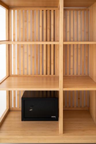 a wooden book shelf with a television in it at Sea Bliss Adults Only in Parga