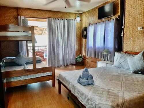 a bedroom with a bed with a stuffed animal on it at Lala Panzi Bed and Breakfast in Puerto Princesa City