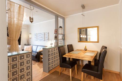 a dining room with a table and chairs and a couch at FeWo Hindenburgstraße 33 in Lüneburg