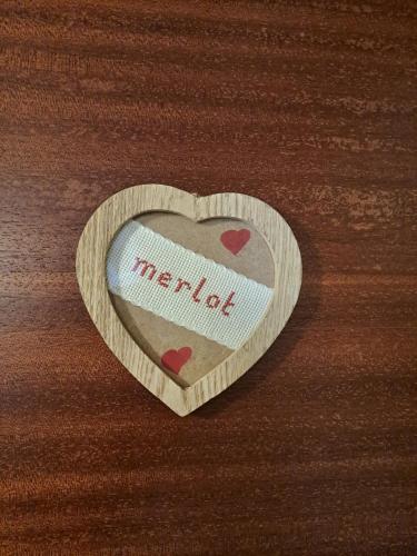 a wooden heart with the word heartbeat written on it at La Piazzetta in Goito