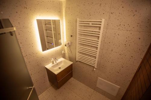 a bathroom with a sink and a mirror at Villa Rexhes in Ferizaj