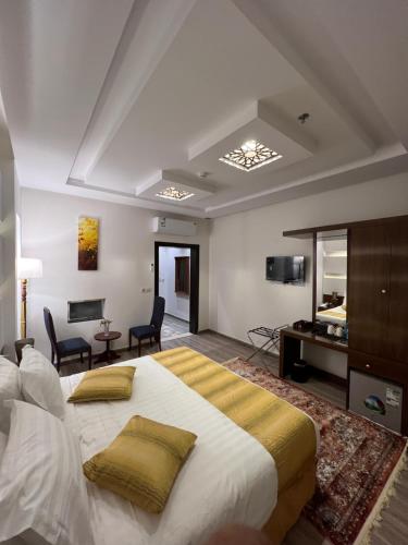 a bedroom with a large bed and a living room at فندق الليالي الحالمة in Medina