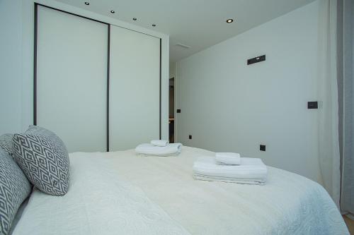 a bedroom with a white bed with a large mirror at 138 Miramar Luxury Relax - Alicante Holiday in La Mata