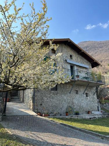 a stone building with a balcony on top of it at Greenlake House Top Village in Tremezzo