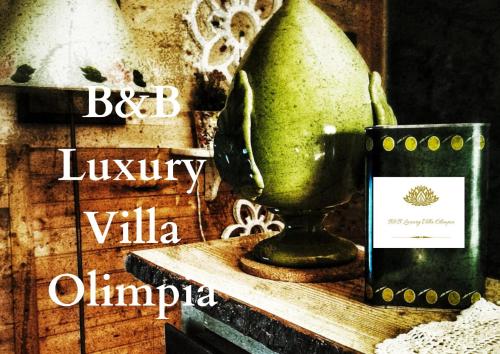 a vase sitting on a table next to a cell phone at B&B Luxury Villa Olimpia Home Restaurant in Selva di Fasano