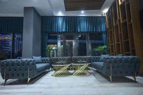 a lobby with couches and tables in a building at Batumi View Luxury in Batumi
