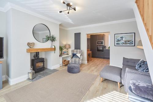 a living room with a couch and a fireplace at Host & Stay - No.8 in Witton Gilbert