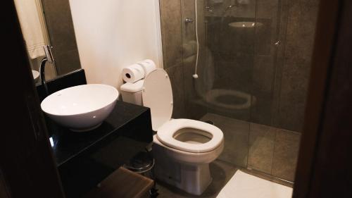 a bathroom with a toilet and a sink and a shower at Delta Maresias Club by Smart Sharing in Maresias