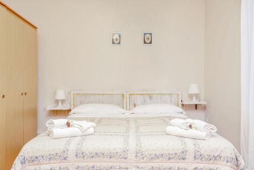 a white bedroom with a bed with towels on it at Il Verde nel Blu in Monterosso al Mare
