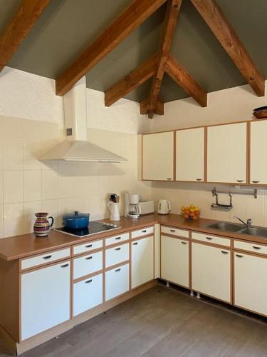 une cuisine avec des armoires blanches et un évier dans l'établissement Magnifique villa avec jardin clos à 5 min des plages à pied, à Dolus-d'Oléron