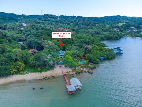 an island with a sign that reads resort guest hugs at Serenity Beach Home in West End