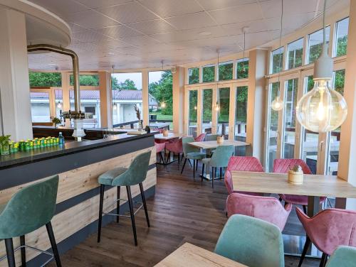 a restaurant with tables and chairs and windows at Friesland Glamping Camp Schortens in Schortens