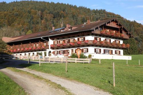 a large building with flowers in front of a road at Gästehaus Kleinbuch in Bad Wiessee