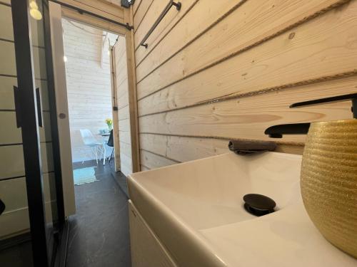 a bathroom with a sink and a wooden wall at GLAMP GLAMOUR***** in Kowale Oleckie