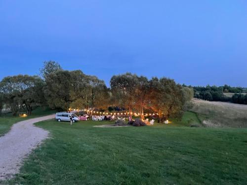 a park with a car parked in a field at GLAMP GLAMOUR***** in Kowale Oleckie