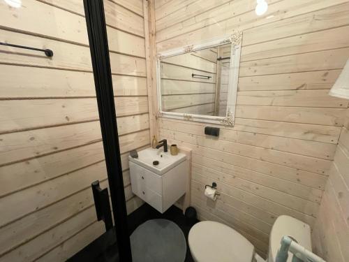a bathroom with a sink and a mirror and two toilets at GLAMP GLAMOUR***** in Kowale Oleckie