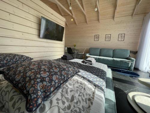 a bedroom with a bed and a couch at GLAMP GLAMOUR***** in Kowale Oleckie