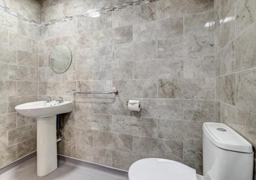 a bathroom with a toilet and a sink at Oddicombe Hall Flat 2 in Torquay