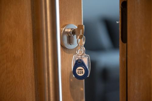 a door key with a house tag on it at C&R APART in Mar del Plata
