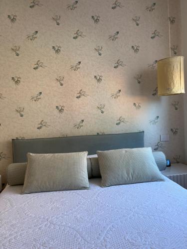 a bed with two pillows in a bedroom at Platessa in Portovenere