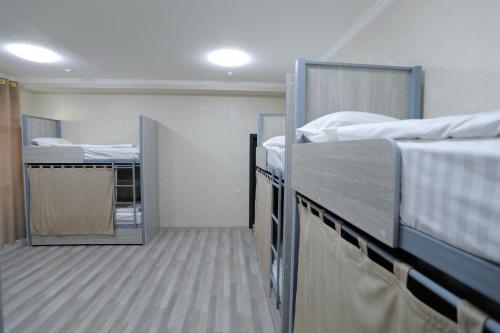 a room with two beds and a mirror in it at 1001-NOCH in Tashkent