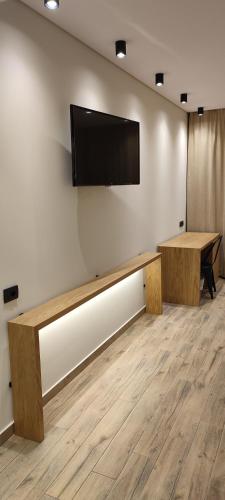 a room with a flat screen tv on a wall at Mary Hotel in Limenas