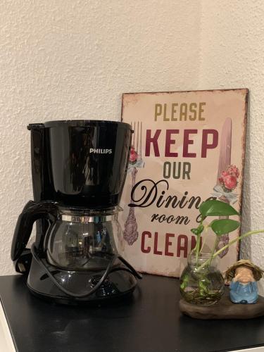 a blender sitting on a counter next to a sign at G Beach Front Villa in Batu Ferringhi