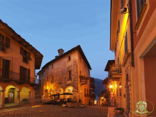 an empty street in an old town at night at Hotel Casa Arizzoli in Cannobio