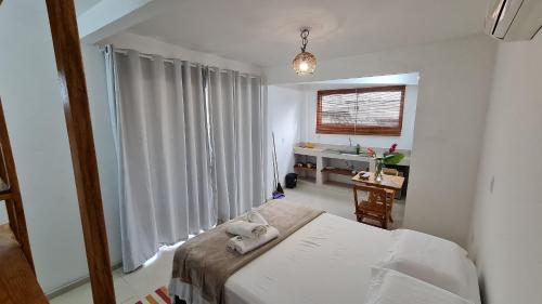 Postel nebo postele na pokoji v ubytování Vila Pitangueira - Flat Terra - No centro de Serra Grande com Piscina, Jacuzzi, Internet Veloz