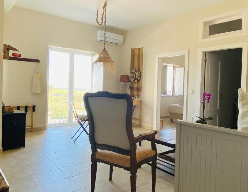 a living room with a chair and a room with a table at The Little Owls Nest Castro Verde in Castro Verde