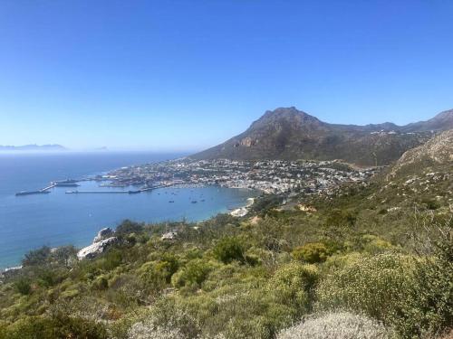 a view of a city and the ocean from a mountain at Restore your Soul, Boulders Beach, Seaforth, Simon's Town in Simonʼs Town