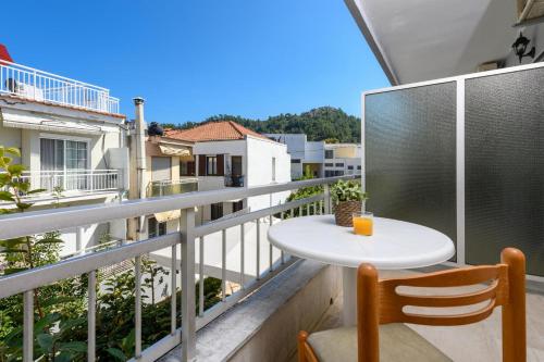 a small table on the balcony of a apartment at Mary Hotel in Limenas