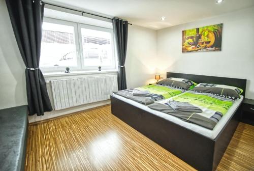 a bedroom with a large bed with a window at Chaloupka víno sklep U Palečků in Zaječí