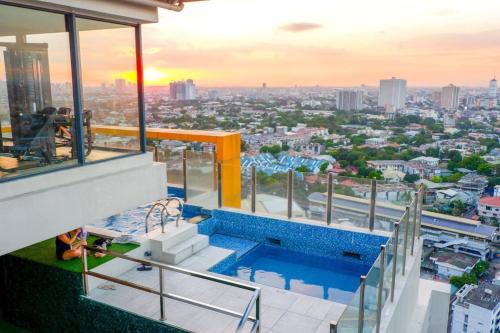 a view from the roof of a building with a swimming pool at Cozy Spacious Hotel Type Condo with PS5 Smart TV and WiFi in Manila