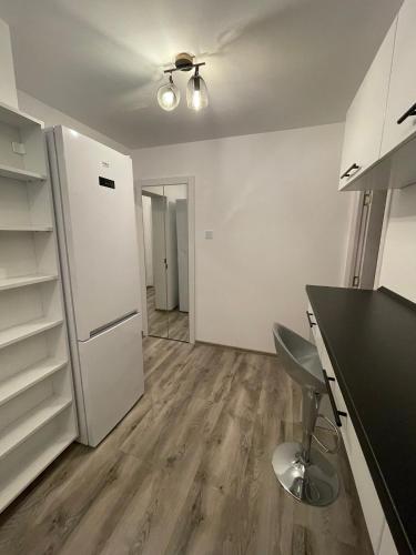 an empty kitchen with a white refrigerator and a table at Apartament 55mp in centru orasului in Giurgiu