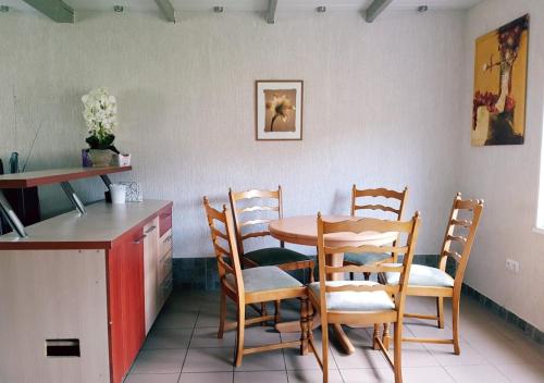 a dining room with a table and chairs and a counter at Vila House in the city center of Ukmerge in Ukmergė