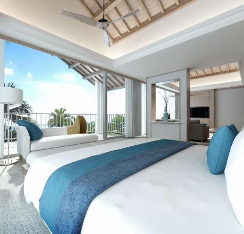 a bedroom with a large bed and a balcony at Palau Sunrise Sea View Landison Retreat in Melekeok