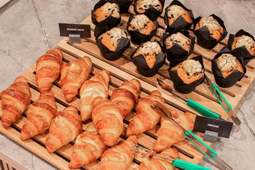 a tray of croissants and other pastries on a table at Hampton By Hilton London City in London