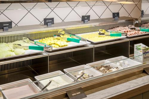 a buffet line with many different types of food at Hampton By Hilton London City in London