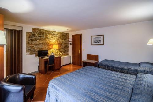 a hotel room with a bed and a desk at Hotel Martelli in Florence
