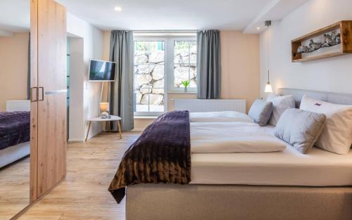 Postel nebo postele na pokoji v ubytování Das Maximilian - Feines Landhotel am Schliersee