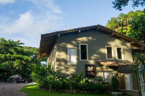 a house with a sign on the side of it at Vila Patí Caraíva in Caraíva