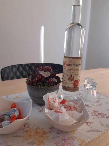 a bottle of wine sitting on top of a table with bowls at Ferienhus Klus 415 in Mellau