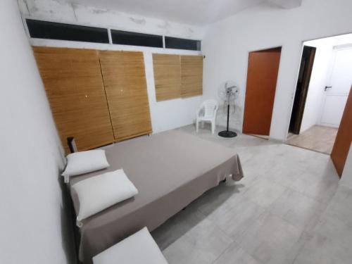a bedroom with a large bed in a room at CASA QUINTA CON ESPECTACULAR VISTA Al RÍO in General Alvear
