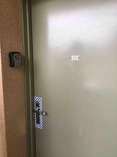 a door with a sign on it with a sticker on it at Studio Golf piscine D Day in Port-en-Bessin-Huppain
