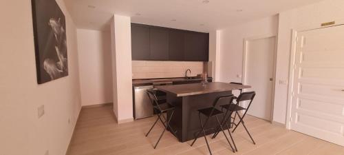 a kitchen with a table and chairs in a room at La colina in Arona