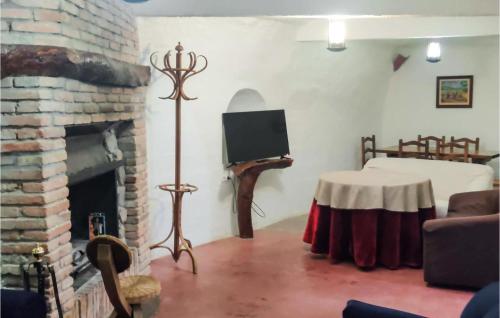a living room with a fireplace and a tv at 2 Bedroom Cozy Home In Baza in Baza