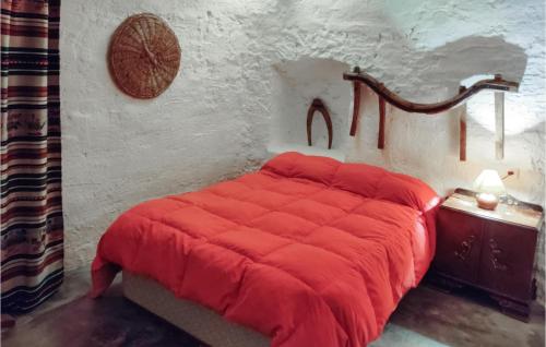 a bedroom with a red bed with a red blanket at 2 Bedroom Cozy Home In Baza in Baza