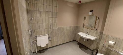 a bathroom with a sink and a mirror at The Crown Inn in Coniston