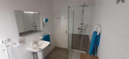 a white bathroom with a sink and a shower at terraza al mar in Pineda de Mar